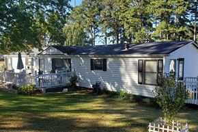Acworth apartment for rent - a white house with a black roof and a large yard