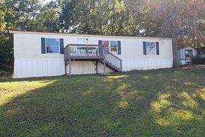 Acworth apartment for rent - a mobile home with a large yard in front of it