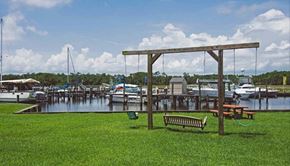 Ocean Springs apartment for rent - a park with a bench and swing next to a marina