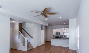 Alexander apartment for rent - a living room with a staircase to the right and a kitchen in the background