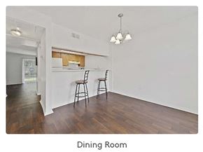 Ocean Springs apartment for rent - a dining room with a table and chairs and a kitchen in the background