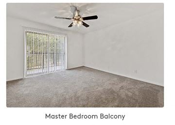 Ocean Springs apartment for rent - A spacious master bedroom balcony with a ceiling fan and a window with a metal grill.