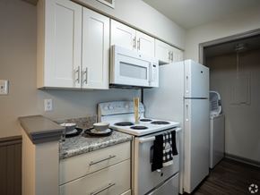 Augusta apartment for rent - A kitchen with white appliances and cabinets.