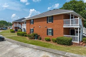 Augusta apartment for rent - A red brick house with a white porch.