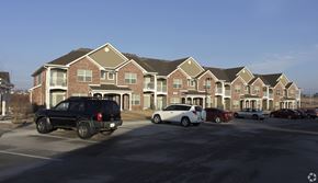 Memphis apartment for rent - A black SUV is parked in front of a brick apartment building.