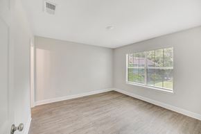 Savannah apartment for rent - an empty bedroom with a large window and wood flooring