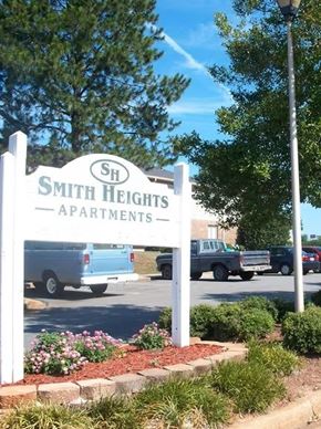 Perry apartment for rent - A sign for Smith Heights Apartments is shown in front of a parking lot.