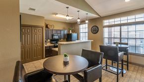 Maumelle apartment for rent - a dining room and kitchen with a table and chairs