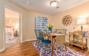 Maumelle apartment for rent - a dining room with a table and chairs and a bedroom with a bed