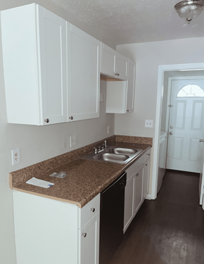 Myrtle Beach apartment for rent - A kitchen with brown granite countertops and white cabinets.