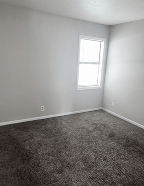 Myrtle Beach apartment for rent - A room with a carpeted floor and a window.