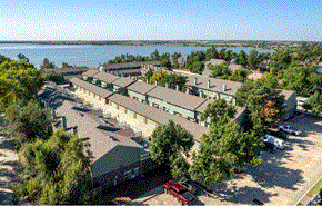 Yukon townhouse for rent - a view from above of a row of houses with a body of water in the background