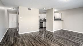 Hickory apartment for rent - an empty living room with a kitchen in the background