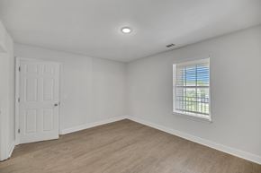 Savannah townhouse for rent - an empty living room with white walls and a window