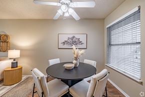Fort Worth apartment for rent - Dining room with round table and upholstered chairs at Highland Park Apartments, Fort Worth, Texas