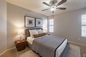 Fort Worth apartment for rent - Bedroom with ceiling fan and wall art at Highland Park Apartments, Texas, 76132