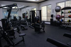 Richardson apartment for rent - Fitness center with strength training equipment and weights at Clearwater Creek Apartments, Richardson, Texas