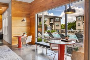 College Station apartment for rent - a dining area with tables and chairs next to a pool