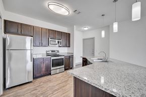 College Station apartment for rent - a kitchen with stainless steel appliances and a granite counter top