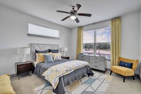 College Station apartment for rent - a bedroom with a bed and a ceiling fan
