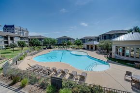 College Station apartment for rent - the preserve at ballantyne commons pool with chairs and apartment buildings