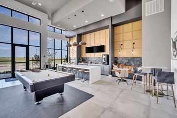 Oklahoma City apartment for rent - a pool table in the center of a living room with a kitchen and a bar