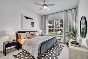 Oklahoma City apartment for rent - a bedroom with a bed and a ceiling fan