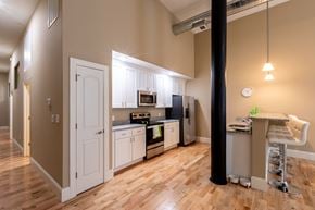 Lawrence apartment for rent - a kitchen with white cabinets and a wood floor