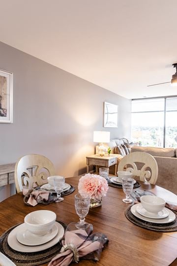 Manchester apartment for rent - a dining room with a wooden table and chairs and a living room