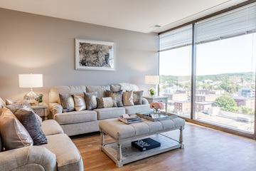 Manchester apartment for rent - a living room with a large window and a couch and a table