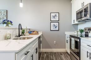 Manchester apartment for rent - A kitchen with a white counter top and a sink.