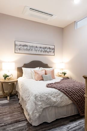 Manchester apartment for rent - A bedroom with a large bed and a painting above it.