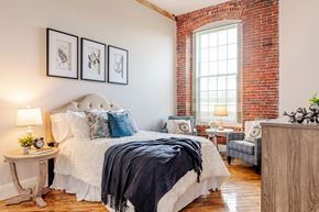 Allenstown apartment for rent - a bedroom with a bed and a chair