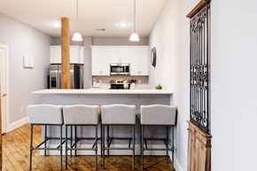 Allenstown apartment for rent - a kitchen with a bar and stools