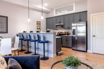 Concord apartment for rent - A kitchen with a bar area and a dining table.