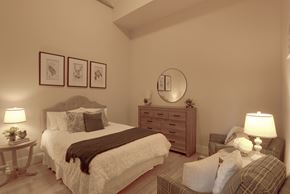 Manchester apartment for rent - a bedroom with a bed and a chair and a mirror