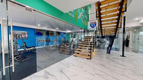 Concord apartment for rent - A gym with a staircase and a glass wall.