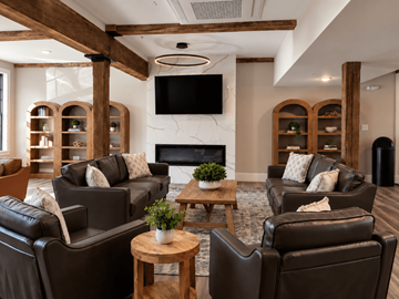 Cranston apartment for rent - A living room with brown leather chairs and a fireplace.