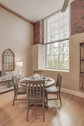 Manchester apartment for rent - a dining room with a table and chairs and a large window