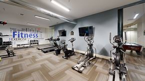Lawrence apartment for rent - A gym with a variety of exercise equipment including treadmills, stationary bikes, and weight machines.