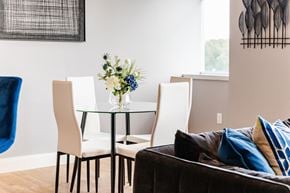 Merrimack apartment for rent - a dining room with a glass table and white chairs