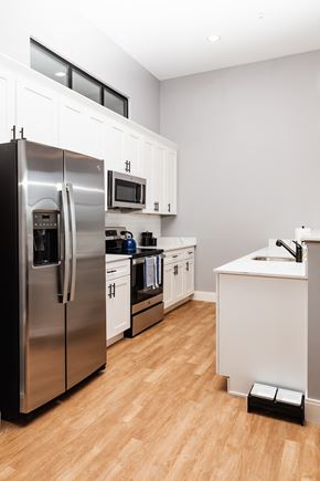 Merrimack apartment for rent - a kitchen with white cabinets and stainless steel appliances