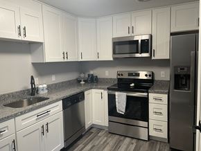 Concord apartment for rent - a kitchen with stainless steel appliances and white cabinets