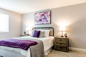 Dover apartment for rent - a bedroom with a bed and two night stands with lamps