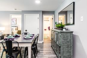 Dover apartment for rent - a dining room with a table and chairs and a large mirror on the wall