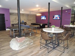 Manchester apartment for rent - a room with tables and chairs and a pool table and a tv