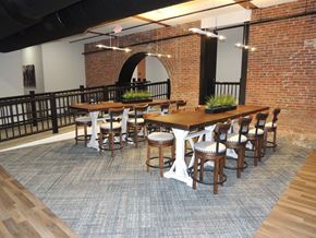 Manchester apartment for rent - a large dining room with tables and chairs and a brick wall