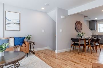 Laconia apartment for rent - A living room with a couch, coffee table, and a painting on the wall.