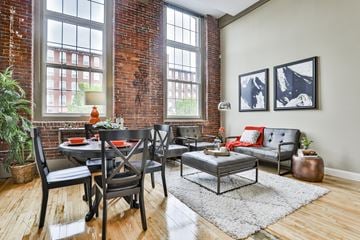 Manchester apartment for rent - a living room with a table and chairs and a brick wall