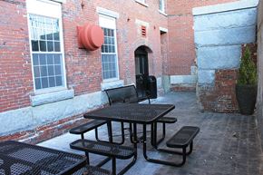 Manchester apartment for rent - a group of tables and chairs outside of a brick building